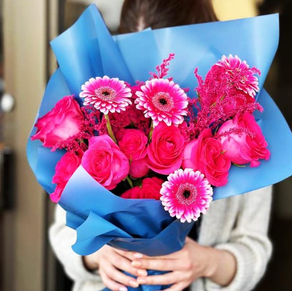 Vibrant Blooms Trio Bouquet featuring luxurious roses, cheerful gerberas, and eye-catching celosia for a vibrant and playful display.
